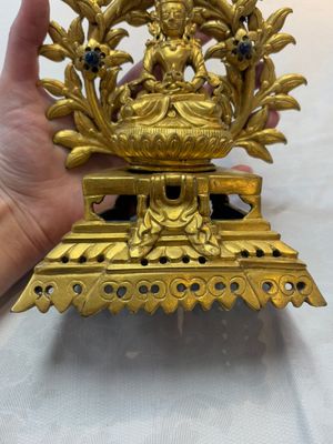 A Nepalese gilt-bronze Buddha on an inscribed throne with a mandorla, 19th C. — photo 7