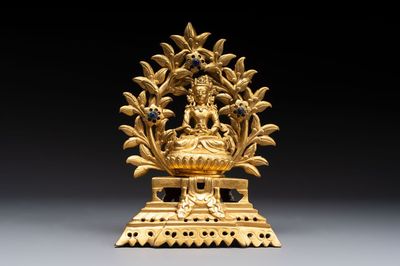 A Nepalese gilt-bronze Buddha on an inscribed throne with a mandorla, 19th C.