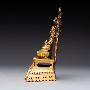 A Nepalese gilt-bronze Buddha on an inscribed throne with a mandorla, 19th C. — photo 4