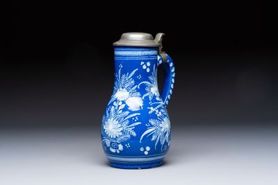 A Nevers white-decorated Persian-blue-ground faience jug with a mounted pewter lid, France, 18th C.