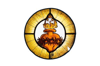 A painted glass 'Sacred Heart of Jesus' medallion, France, 17th C.