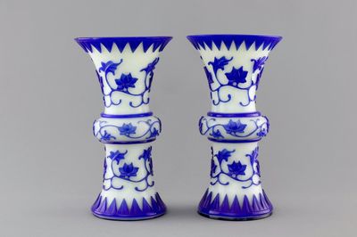 A pair of blue and white Chinese Peking overlay glass yenyen vases, early 20th C.