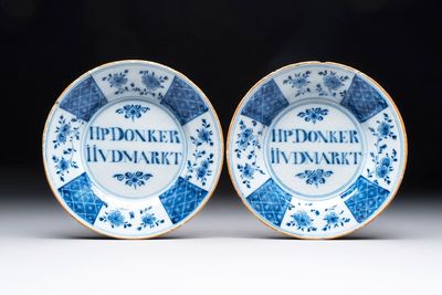 A pair of blue and white Dutch Delft inscribed plates, 18th C.