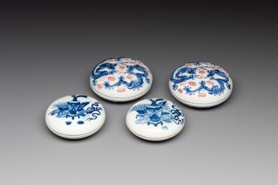 A pair of Chinese blue and white and a pair of blue, white and copper-red seal paste boxes, Kangxi and Qianlong mark, 19th C.