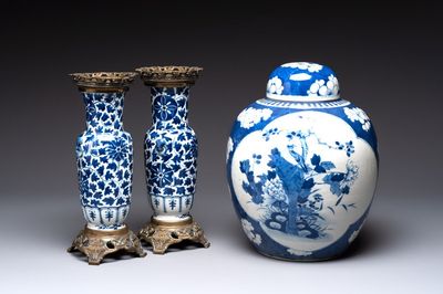 A pair of Chinese blue and white bronze-mounted vases and a covered jar, 19th C.