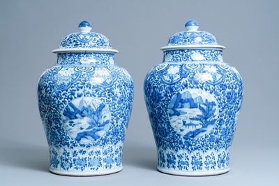 A pair of Chinese blue and white covered vases with landscape medallions on a floral ground, Kangxi