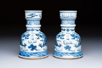 A pair of Chinese blue and white 'Dragons Chasing the Flaming Pearl’ candlesticks, 19th C.