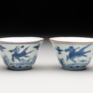 A pair of Chinese blue and white 'flying horses' cups, Jiajing mark, Kangxi — photo 1