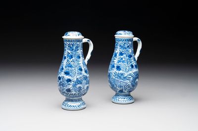 A pair of Chinese blue and white jugs and covers with floral design, Kangxi