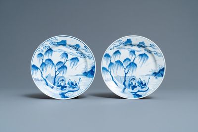 A pair of Chinese blue and white plates with a boat near the shore, Chenghua mark, Kangxi