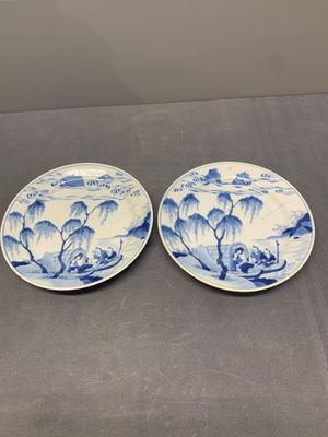 A pair of Chinese blue and white plates with a breastfeeding woman and fishermen on boats, Chenghua mark, Kangxi — photo 1