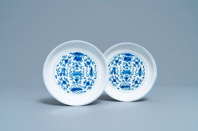 A pair of Chinese blue and white plates with taoist symbols, Kangxi mark and of the period