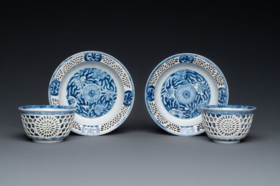 A pair of Chinese blue and white reticulated double-walled cups and saucers, Kangxi