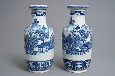 A pair of Chinese blue and white rouleau vases with landscape design, 19th C.