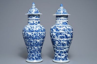 A pair of Chinese blue and white vases and covers with landscape panels, Kangxi