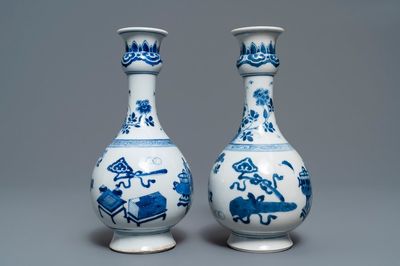 A pair of Chinese blue and white vases with antiquities and flowers, Kangxi