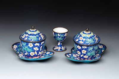 A pair of Chinese blue-ground Canton enamel covered bowls on stands and an egg cup, Qianlong/Jiaqing