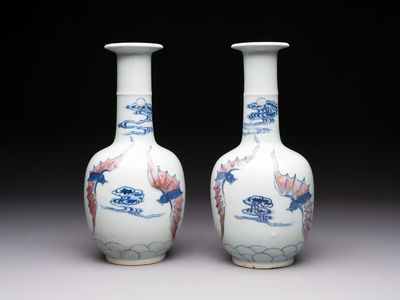 A pair of Chinese blue, white and copper-red 'bats among the clouds' vases, 19th C.