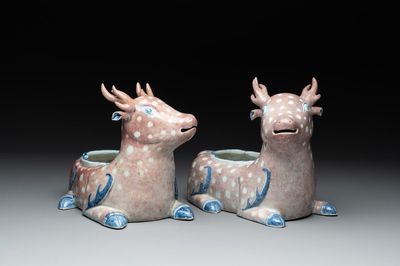 A pair of Chinese blue, white and copper-red stag-shaped jardinières, 19th C.