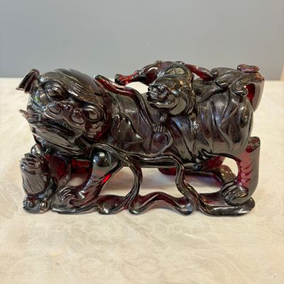 A pair of Chinese carved cherry amber 'Buddhist lions' groups — photo 13
