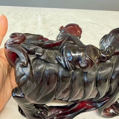 A pair of Chinese carved cherry amber 'Buddhist lions' groups — photo 22