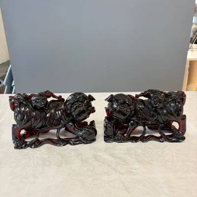 A pair of Chinese carved cherry amber 'Buddhist lions' groups — photo 1