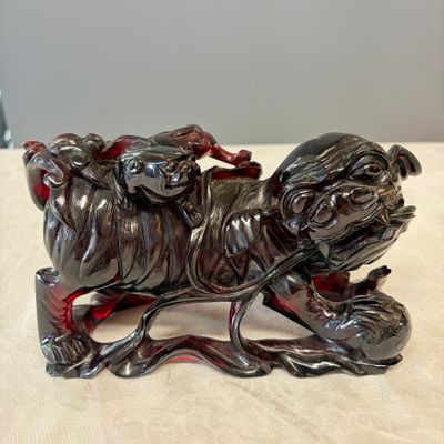 A pair of Chinese carved cherry amber 'Buddhist lions' groups — photo 2