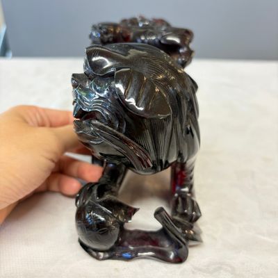 A pair of Chinese carved cherry amber 'Buddhist lions' groups — photo 3