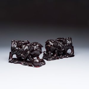A pair of Chinese carved cherry amber 'Buddhist lions' groups — photo 1