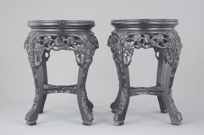 A pair of Chinese carved darkened wood vase stands with marble top, 20th C.