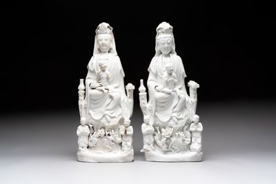 A pair of Chinese Dehua blanc de Chine groups of Guanyin with a child and servants, 18th C.