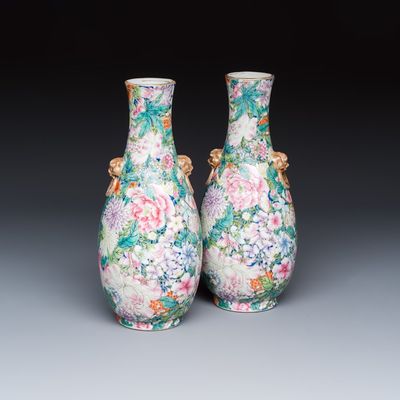 A pair of Chinese famille rose 'Millefleurs' vases with lion-head handles, Qianlong mark, Republic