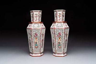 A pair of Chinese famille rose reticulated double-walled 'mandarin subject' vases, Qianlong
