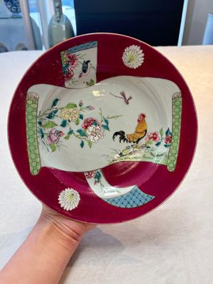 A pair of Chinese famille rose ruby-ground 'scrolls and rooster' plates, Yongzheng — photo 1