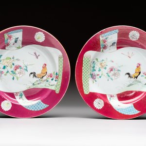 A pair of Chinese famille rose ruby-ground 'scrolls and rooster' plates, Yongzheng — photo 1