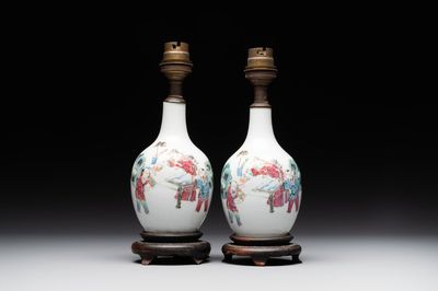 A pair of Chinese famille rose vases with figural design mounted as lamps, 19th C.