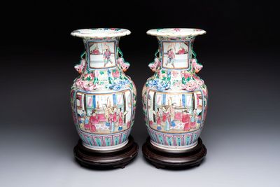 A pair of Chinese famille rose vases with narrative design on wooden stands, 19th C.