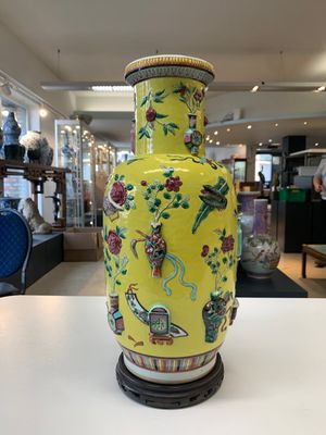A pair of Chinese famille rose yellow-ground relief-decorated vases with wooden stands, 19th C. — photo 13