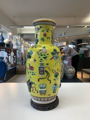 A pair of Chinese famille rose yellow-ground relief-decorated vases with wooden stands, 19th C. — photo 14