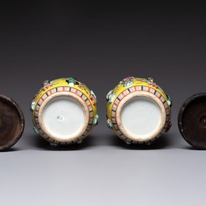 A pair of Chinese famille rose yellow-ground relief-decorated vases with wooden stands, 19th C. — photo 6
