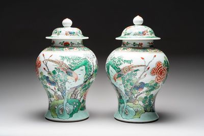 A pair of Chinese famille verte 'birds and flowers' vases and covers, 19th C.