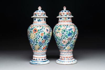 A pair of Chinese famille verte vases and covers with floral design, Kangxi