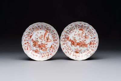 A pair of Chinese gilt iron-red-decorated 'Falconry' plates, Kangxi