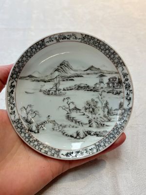 A pair of Chinese grisaille and iron-red 'landscape' cups and saucers, Yongzheng/Qianlong — photo 1