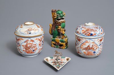A pair of Chinese Imari style bowls and covers, a heart-shaped famille verte saucer and a sancai lion, Kangxi