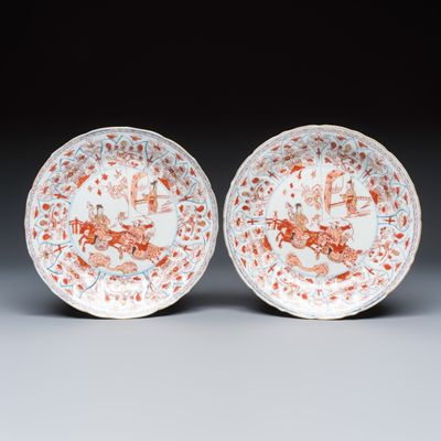 A pair of Chinese iron-red and gilt-decorated 'Falconry' plates, Kangxi