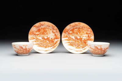 A pair of Chinese iron-red-decorated 'deer hunting' cups and saucers, Qianlong