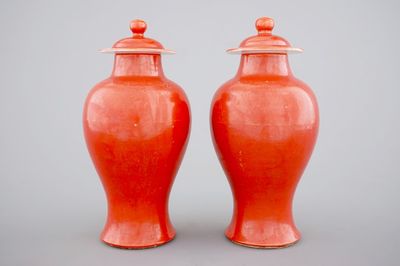A pair of Chinese monochrome coral ground baluster vases with cover, 19th C.