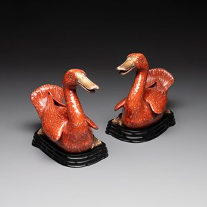 A pair of Chinese partly gilt coral-red-glazed models of ducks on wooden stands, 20th C. — photo 1