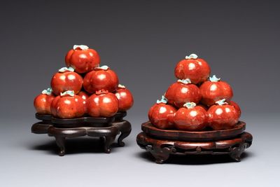 A pair of Chinese polychrome 'persimmons' groups on wooden stands, 19th C.